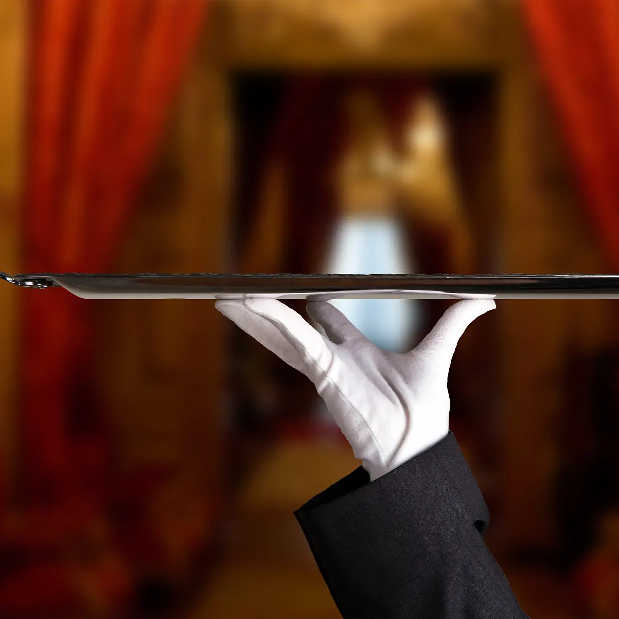 Eleganter Servicemitarbeiter hält ein silbernes Tablett mit perfekter Haltung und demonstriert exzellente Servicequalität im Rahmen eines professionellen Hotel Qualitätschecks